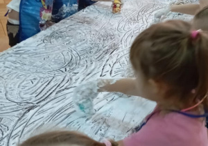 Zabawy autkami na stolikach wysmarowanych pianką