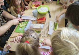 Dzieci patrzą jak się kroi warzywa do sushi