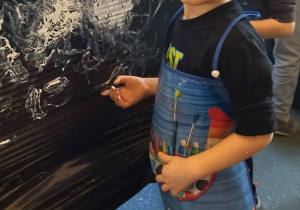 chłopiec maluje palcami